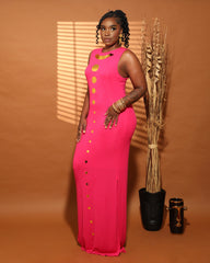 Front view of model wearing a soft knit maxi dress with gold circle accents that cascade down the center front of the dress. Dress is sleeveless and is made in a eco friendly knit jersey with a light sweater texture. Garment is partially lined with matching fabric and back invisible zipper. Garment features great stretch.