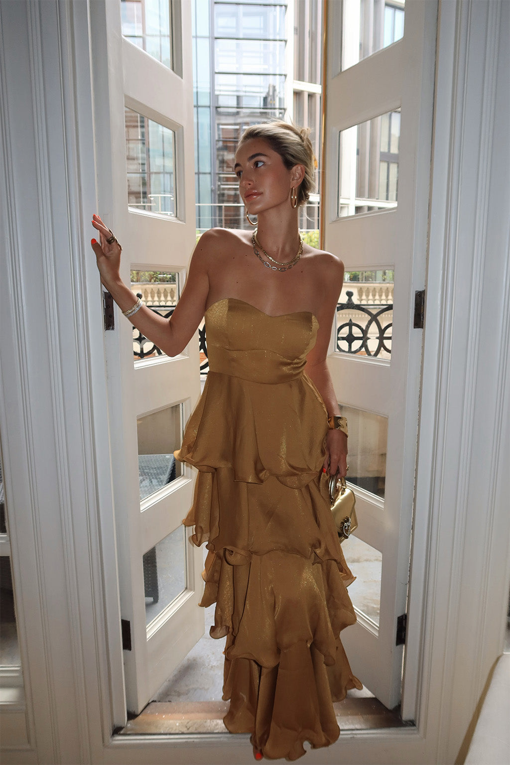 Gold ruffled maxi dress with elegant accents, a gold fringe dress essential.