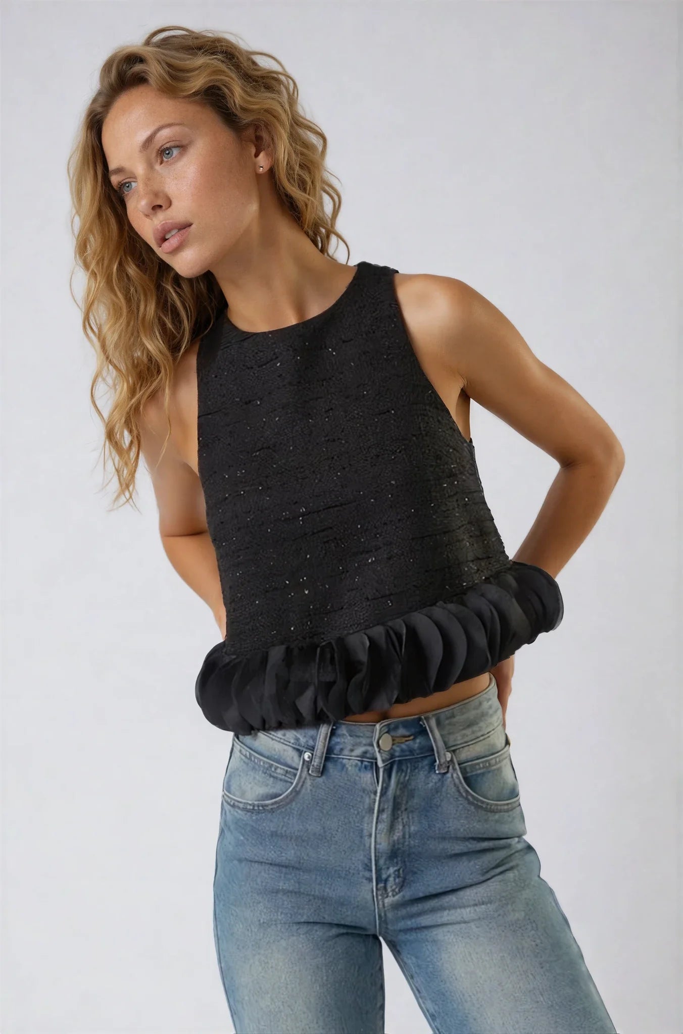 black tweed sleeveless top with ruffled hem