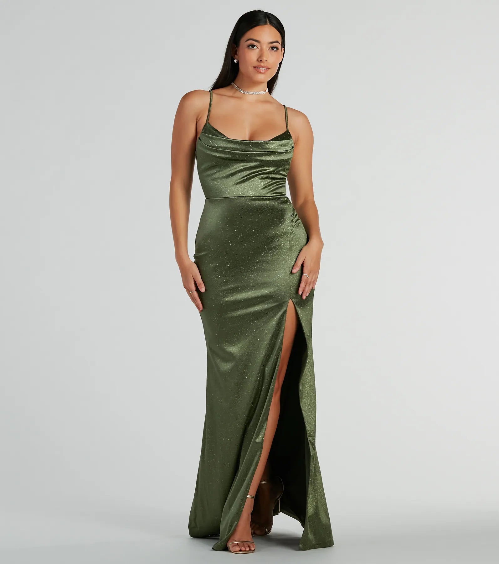 The Melody Cowl Neck Mermaid Glitter Satin Formal Dress is a shimmery olive glitter dress that catches the light beautifully, perfect for any special outfit like Winter Formal attire, clubwear, or a wedding guest dress.