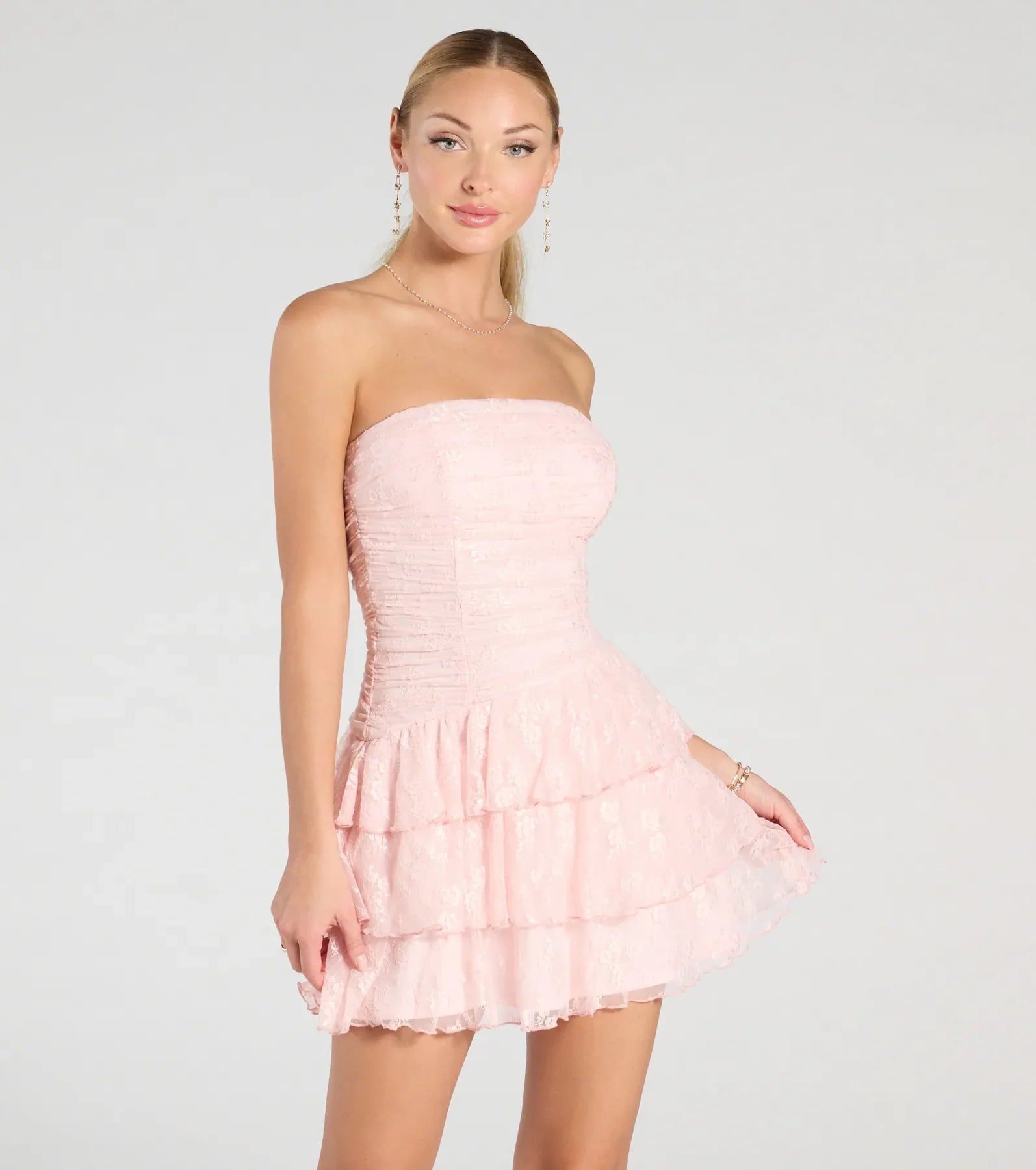 Bring a fun and feminine vibe with the Lovely Nights Strapless Lace Ruffle Skater Dress, a scroll-stopping style from Windsor's pink homecoming dress collection that brings playful charm to every HOCO moment.