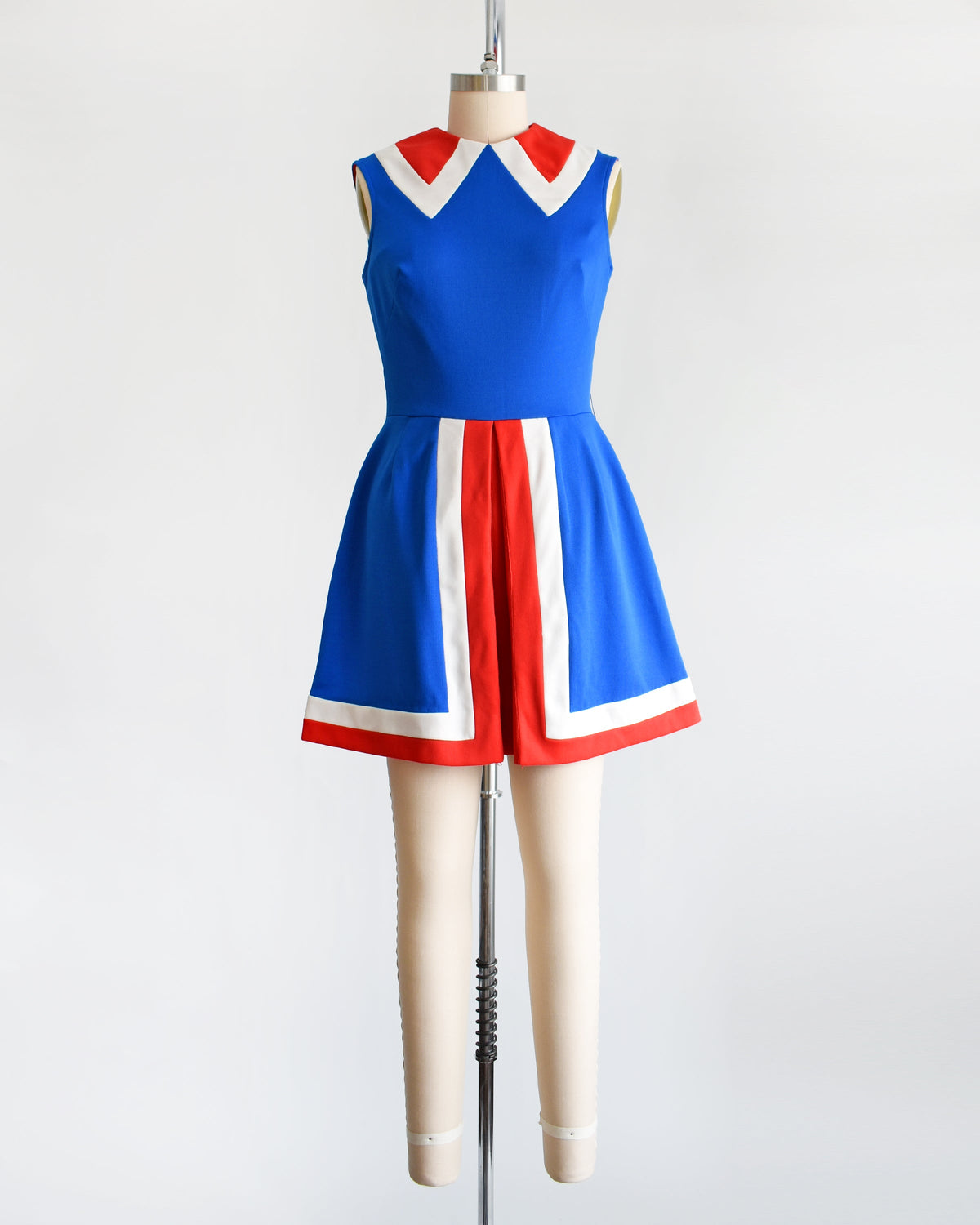 a vintage 60s/70s blue and red mod mini dress on a mannequin against a white background