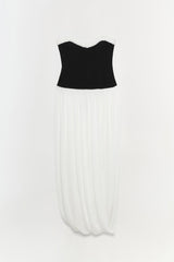 Strapless dress with black bustier top, white lace neckline trim, and ivory pleated skirt.