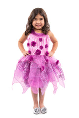 A young dark haired girl dressed in a purple fairy costume with a soft stretch bodice covered in flowers and an organza overskirt, standing on a white background.