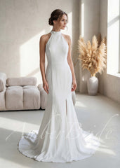 Simple white satin mermaid wedding dress with a halter neckline, fitted bodice, and a side slit.