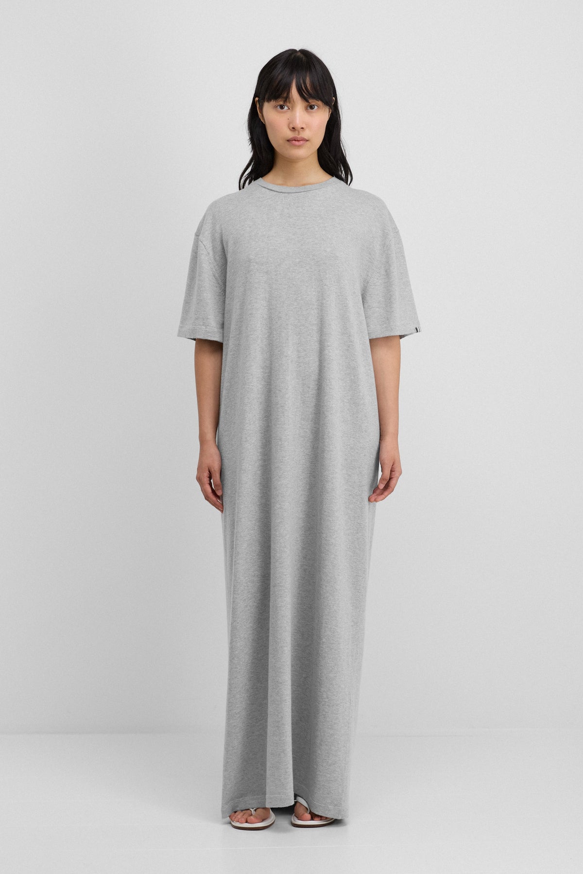 woman wearing a grey floor-length  cotton cashmere t-shirt dress.