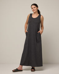 Model wearing Audrey TENCEL™ Maxi Dress in Black Heather. Audrey TENCEL™ Maxi Dress is a merino wool sleeveless, scoop neck, maxi shift dress with pockets available in sizes XS-3X.