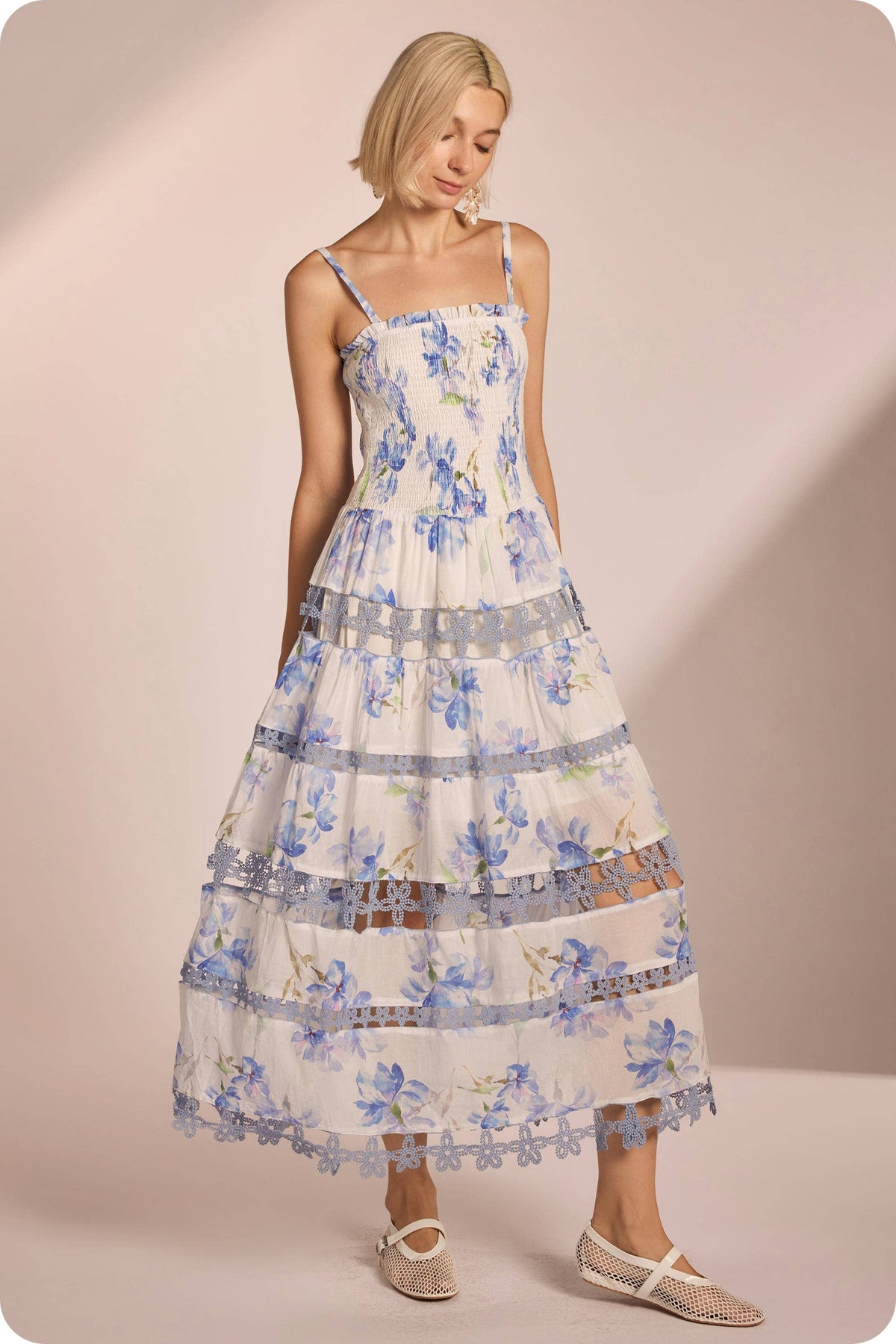 Floral print smocked midi dress with lace trim, featuring delicate blue flowers on a light background, perfect for Long Island boutique fashion.