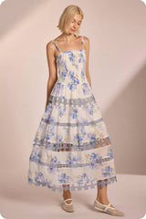 Floral print smocked midi dress with lace trim, featuring delicate blue flowers on a light background, perfect for Long Island boutique fashion.