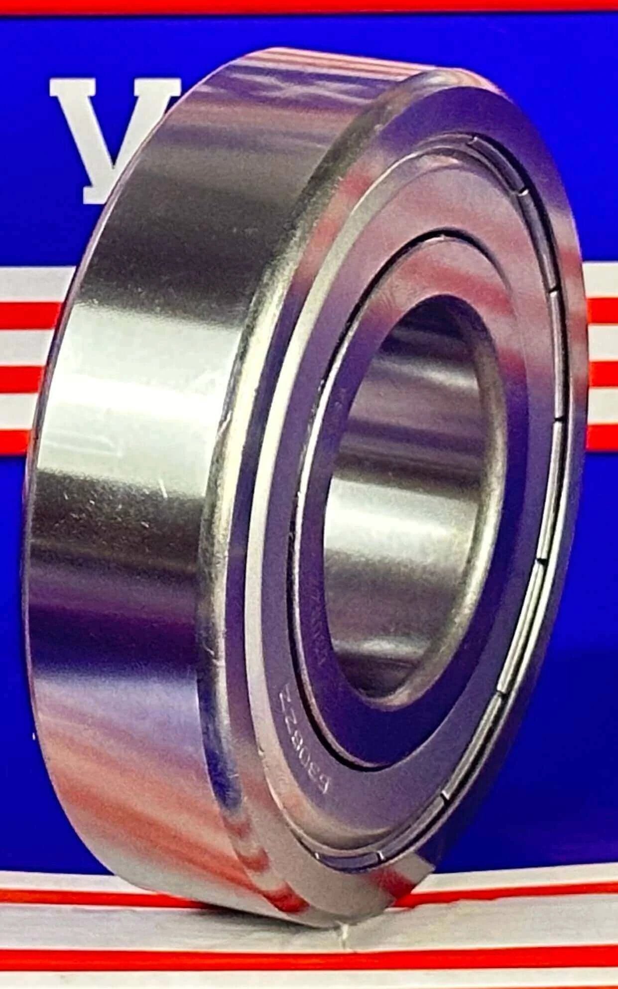 Side view of 6308Z C3 Metal Shielded Bearing - C3 Clearance 40x90x23mm with double metal shields against blue background.