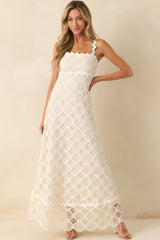 Full length shot of the maxi dress highlighting the ivory lining beneath the lace overlay and the scalloped edge created by the ric rac trim.