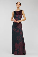 Woman wearing a dark floral patterned dress on a light gray background