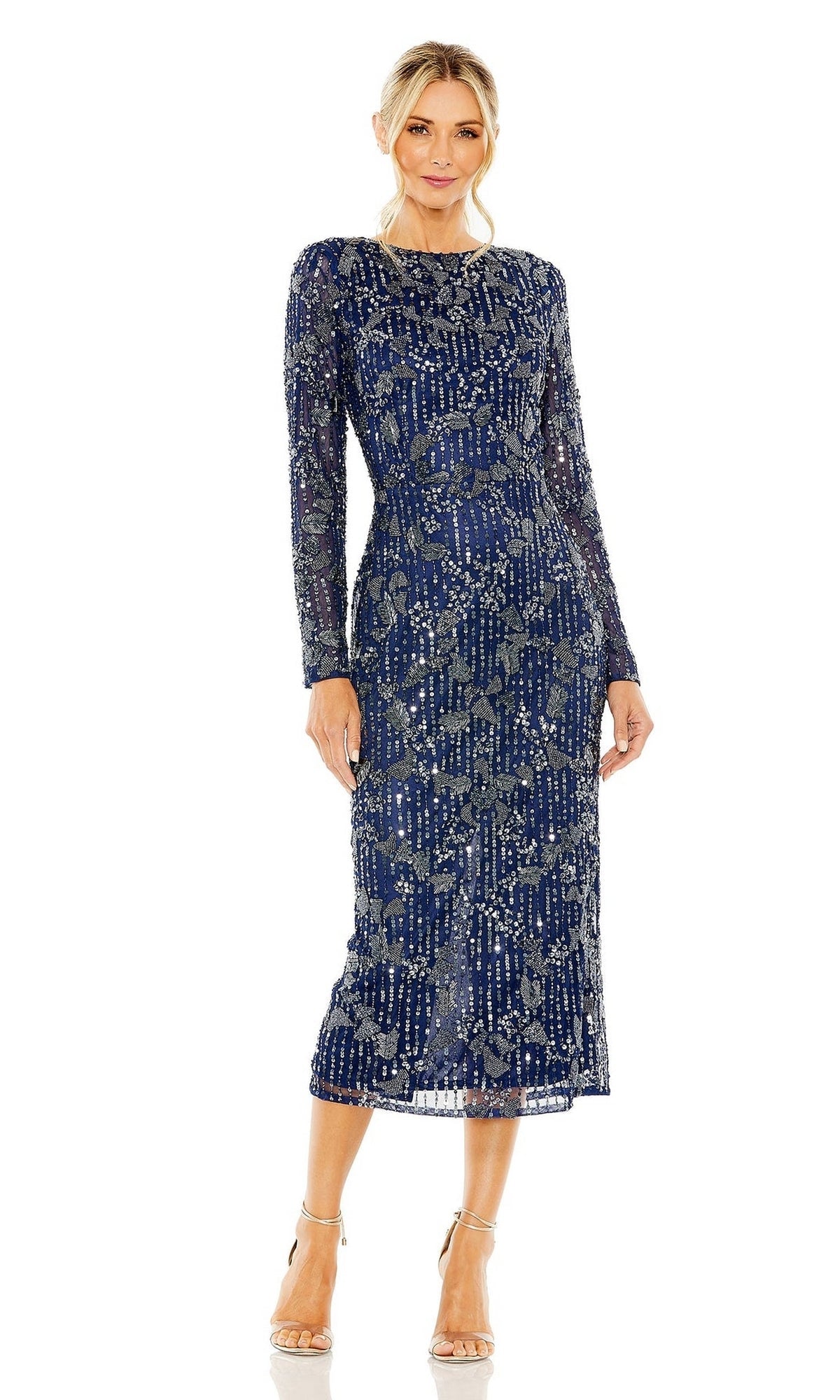 A woman wearing the Mac Duggal 5988, a navy blue, long-sleeve beaded midi wedding guest dress with a round neckline, paired with nude high-heeled sandals.
