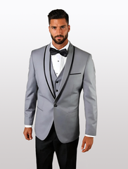 The man confidently wears a Statement Men's Grey with Black Lapel Vested 100% Wool Tuxedo, paired with a black bow tie and crisp white shirt against a plain backdrop.