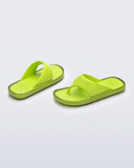 Angled view of a pair of green Float flip flops