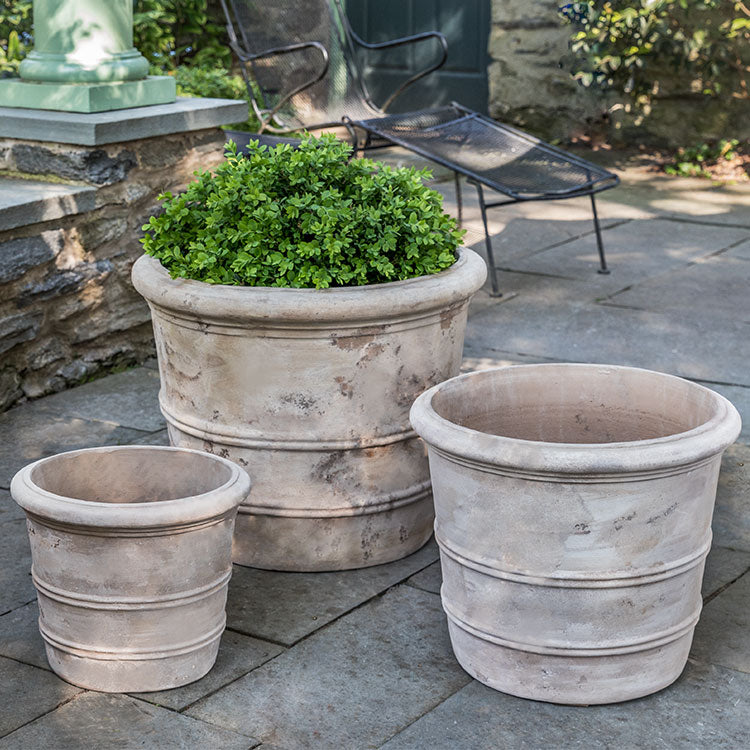 Grouping of 3 containers in front of low wall