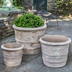 Grouping of 3 containers in front of low wall