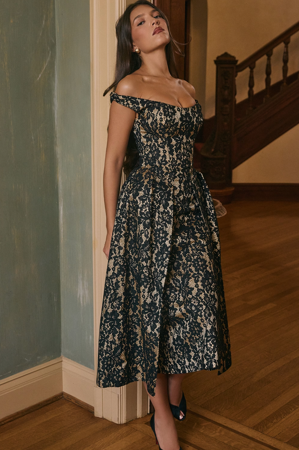 Indulge in romantic elegance with the Black Gold Lace Midi Gown. The intricate lace overlay and off-shoulder neckline exude a touch of romance, while the cinched waist and tulle layered overskirt add a modern twist. With a mid-calf hem, this gown strikes the perfect balance between timeless and dramatic, making it perfect for any special occasion.