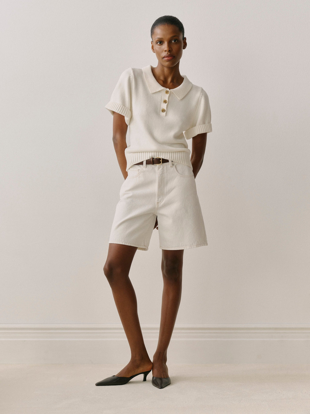Woman wearing a white outfit with a plain background