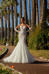 Fit-and-flare lace mermaid wedding dress with open back.