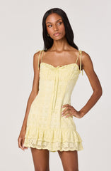 Yellow eyelet sundress with spaghetti straps and ruffled hem.