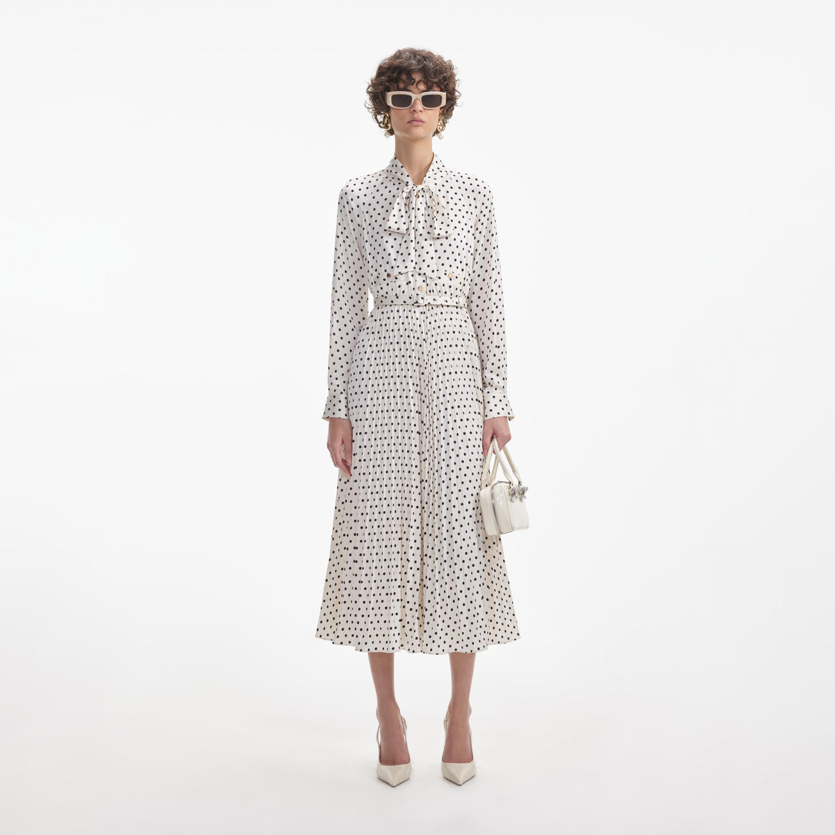 Front view of a woman wearing the Cream Polka Dot Satin Midi Dress