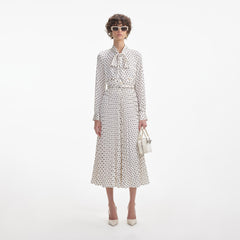 Front view of a woman wearing the Cream Polka Dot Satin Midi Dress