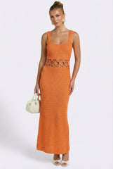 Woman wearing an orange dress with a white background