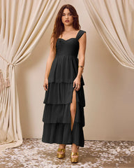 Black tiered maxi dress featuring a high slit and sweetheart neckline, elegantly flowing to the floor.