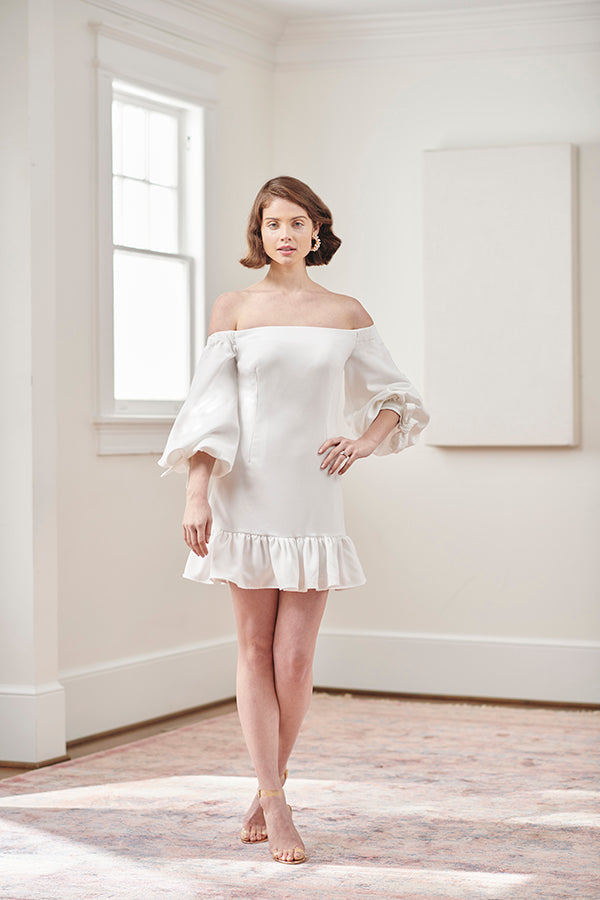 Modern bride in elegant designer off shoulder balloon sleeve short white cocktail party wedding dress
