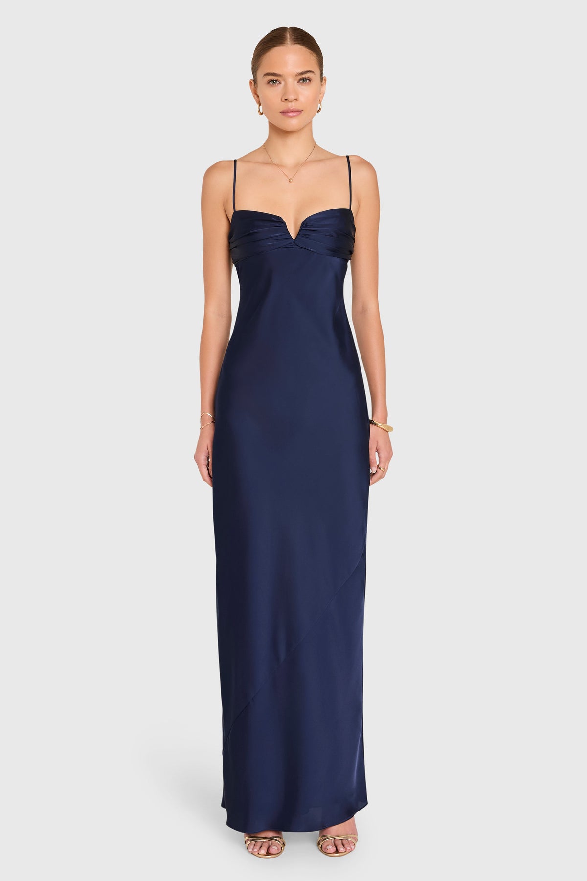 Woman wearing a navy blue evening gown on a white background