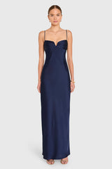 Woman wearing a navy blue evening gown on a white background
