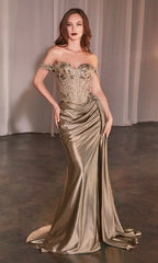 A woman in the Ladivine CD803 Off-the-Shoulder Long Prom Dress, featuring a metallic gold beaded corset-style bodice, draped satin skirt, and slight train, stands on a dark floor with sheer curtains behind her.