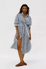 Woman wearing a black and white striped dress on a white background