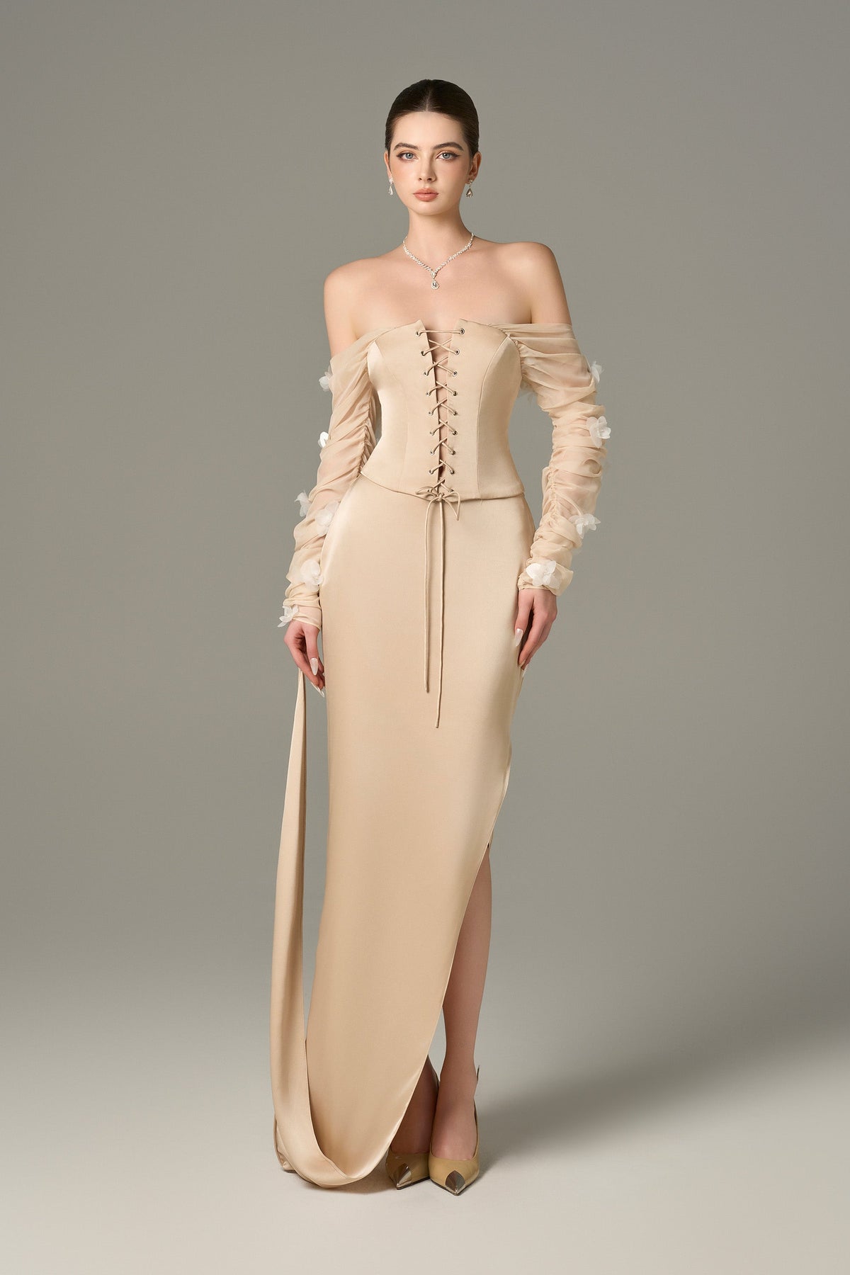 The Cream Chiffon Silk Corset and Maxi Set feature a lace-up corset and ruffle floral sleeves.