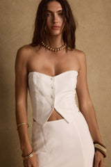 White linen strapless top with refined accents, a white feather top essential.