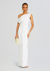 Full-length white linen off-shoulder maxi dress on a model, holding a cream beaded clutch.