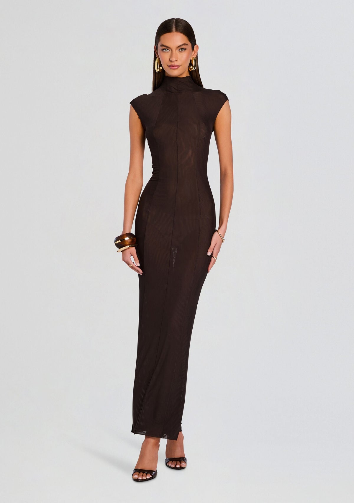 Full-length view of a model in a dark chocolate Laissa Mesh Maxi Dress with a high neck and cap sleeves
