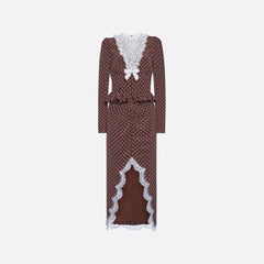 White polka dot print on brown cr√™pe de chine midi dress with long sleeves and lace bib detail, featuring ruffle trim and a lace front slit.