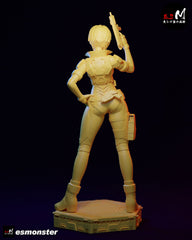 Rear unpainted view of Motoko Kusanagi statue showing armor plating and holstered pistol on display base.
