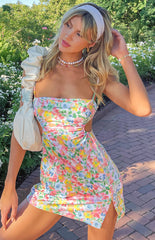 Multi floral Jenna Cut Out Mini Dress with a straight neckline, spaghetti straps, side waist cut-outs, and a thigh slit