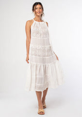 [Color: Bone] A woman wearing a sheer white bohemian midi dress with a tie shoulder detail. A bohemian swim beach cover up dress.