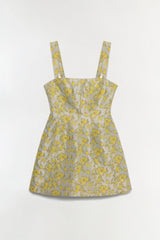 Mini dress with yellow floral jacquard pattern and square neckline straps on neutral background.