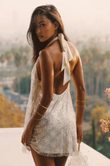 White beaded mini dress with refined detailing and a flattering silhouette.