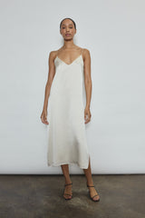 Front view of a model wearing the ivory silk charmeuse Kamperett Sade Slip Dress, a straight-cut midi with corded straps.