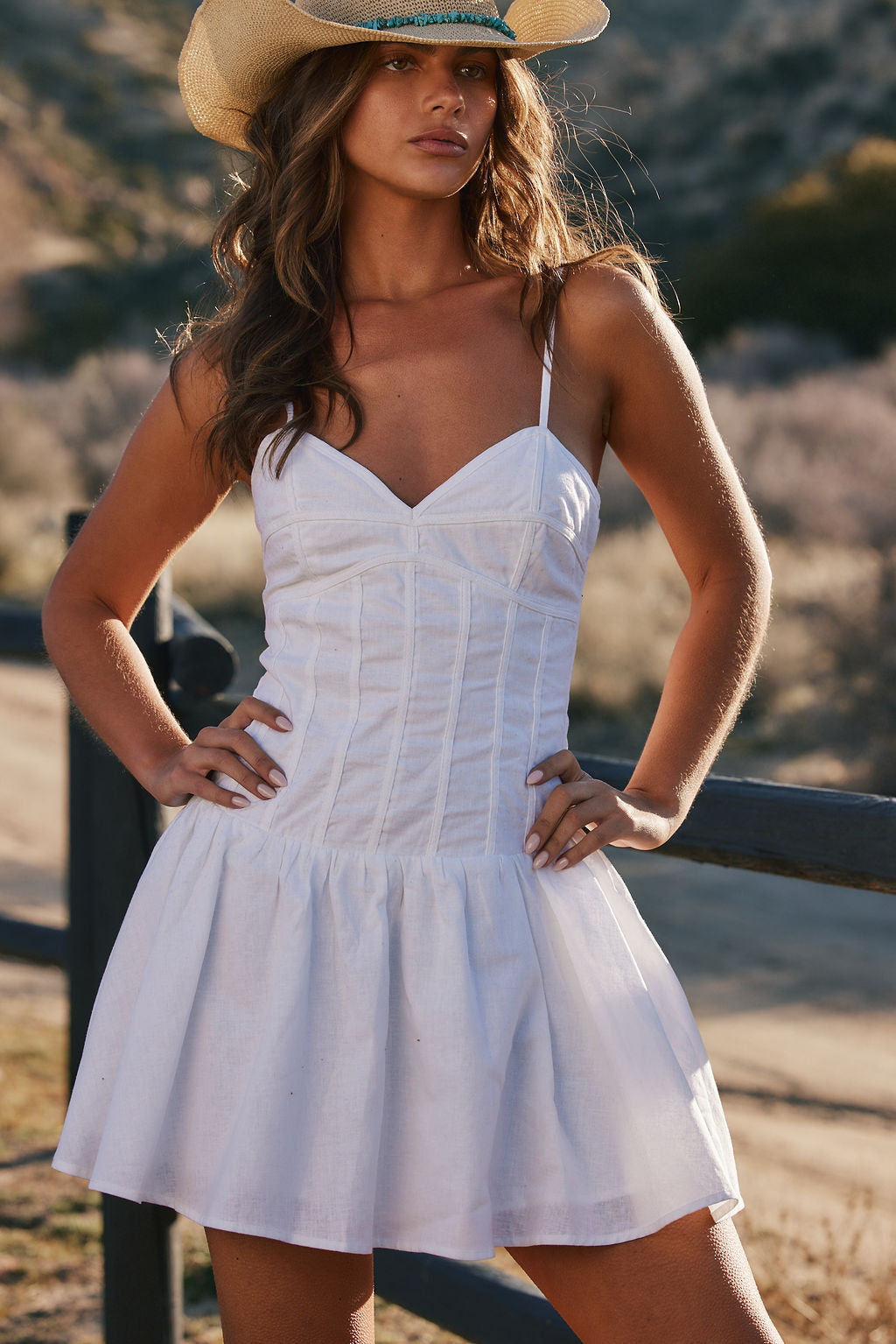 White drop-waist mini dress with elegant accents, a white sequin dress essential.
