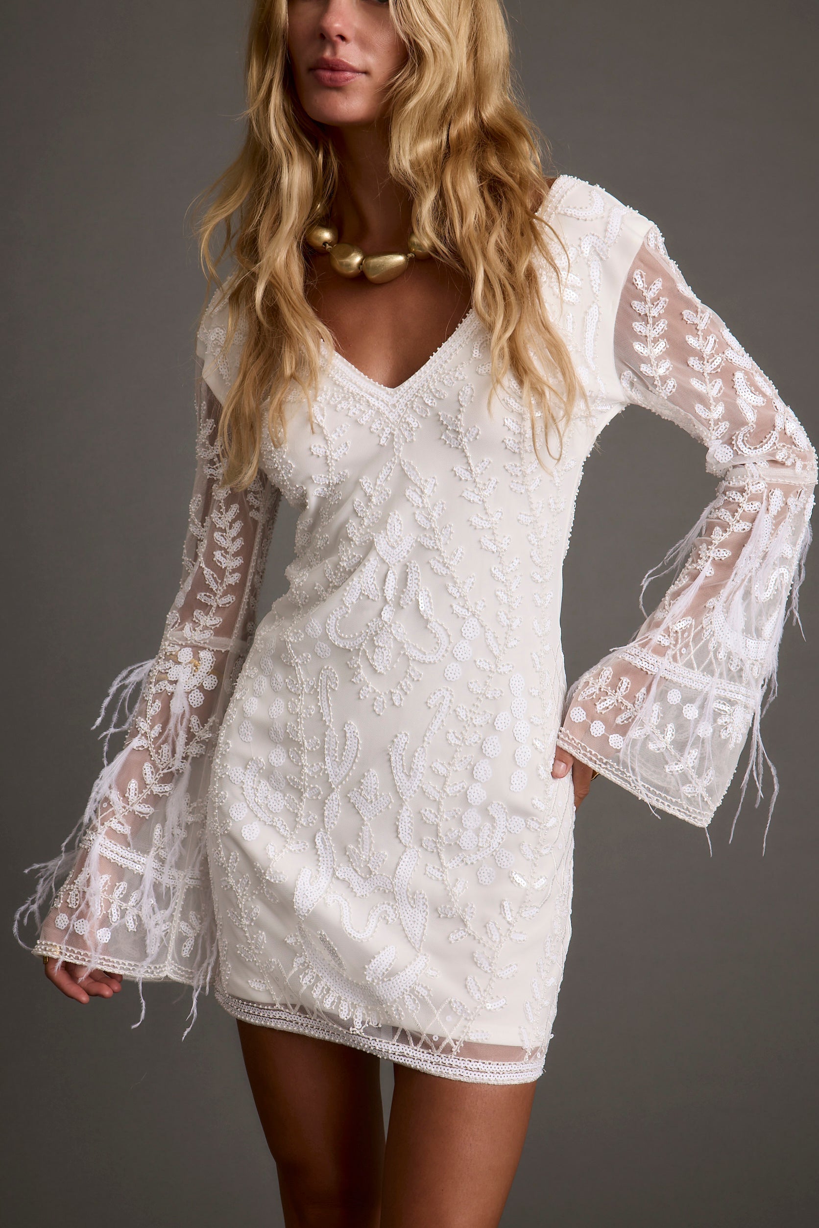 White sequin dress with refined accents, a sparkly white dress long sleeve essential.