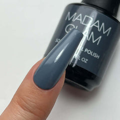Nail polish bottle with a blue nail color swatch on a white background