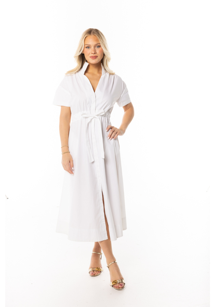 A woman wearing a white dress with a stand collar, wide belt, and pleated shoulder, against a white background.