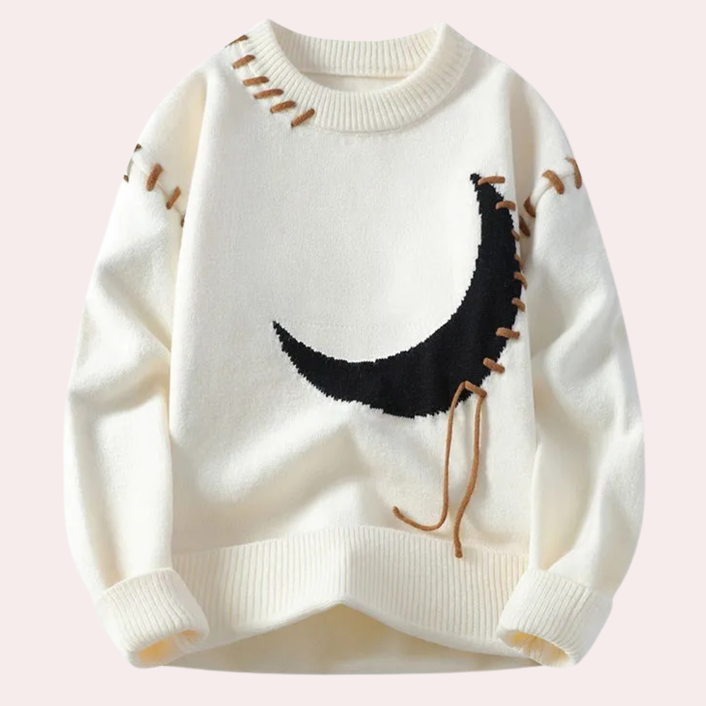 Hvit genser med svart månemotiv og brune sømmer, unisex design, strikket i mykt materiale. Perfekt for høst- og vintermote.